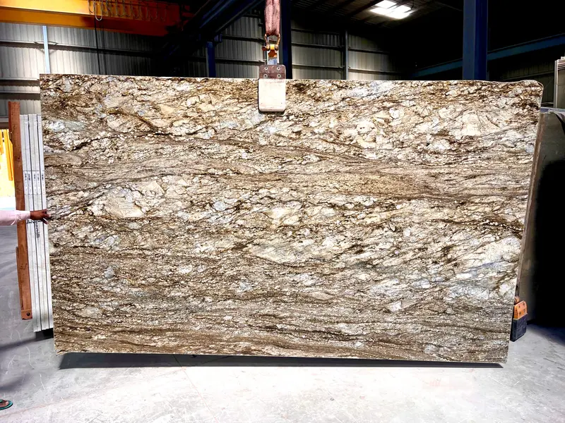 Golden Blue Dunes Granite large gangsaw slab showcasing dramatic golden and grey movement at processing facility